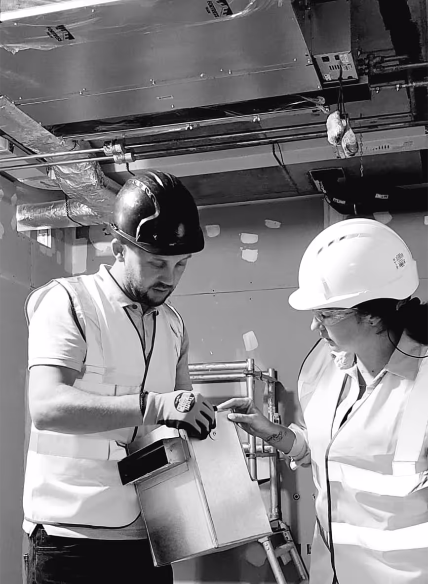 Domani Ventilation engineers inspecting an MVHR unit during a London installation