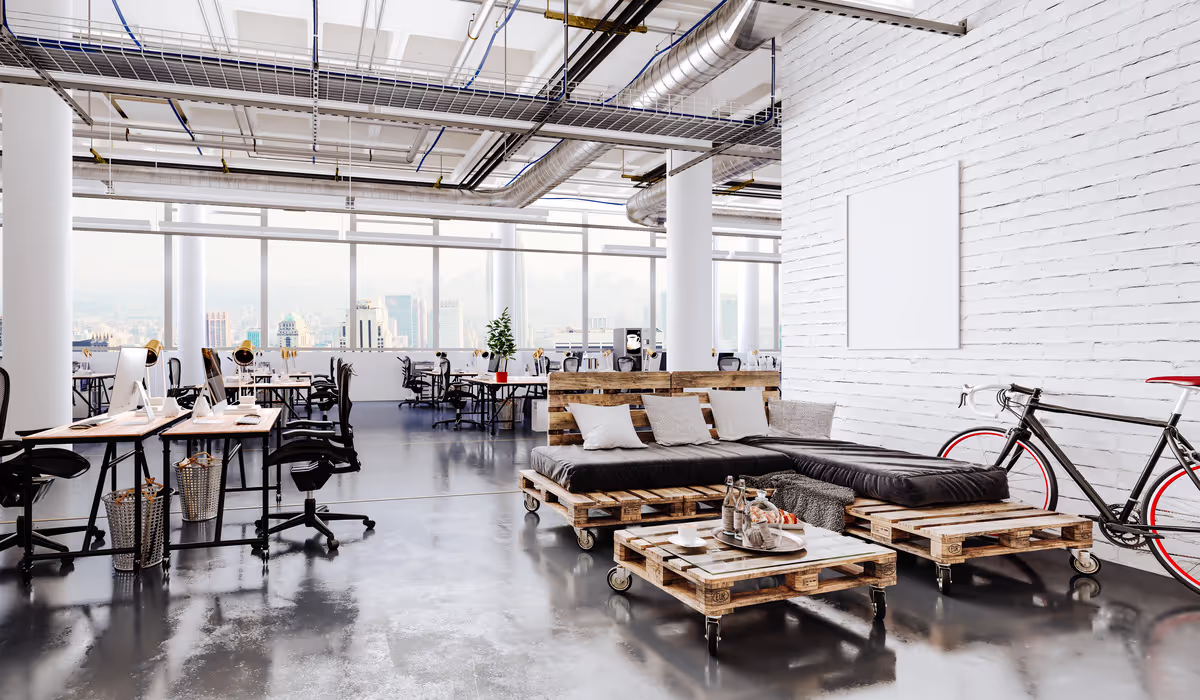 Bright commercial workspace with exposed services and mechanical ventilation