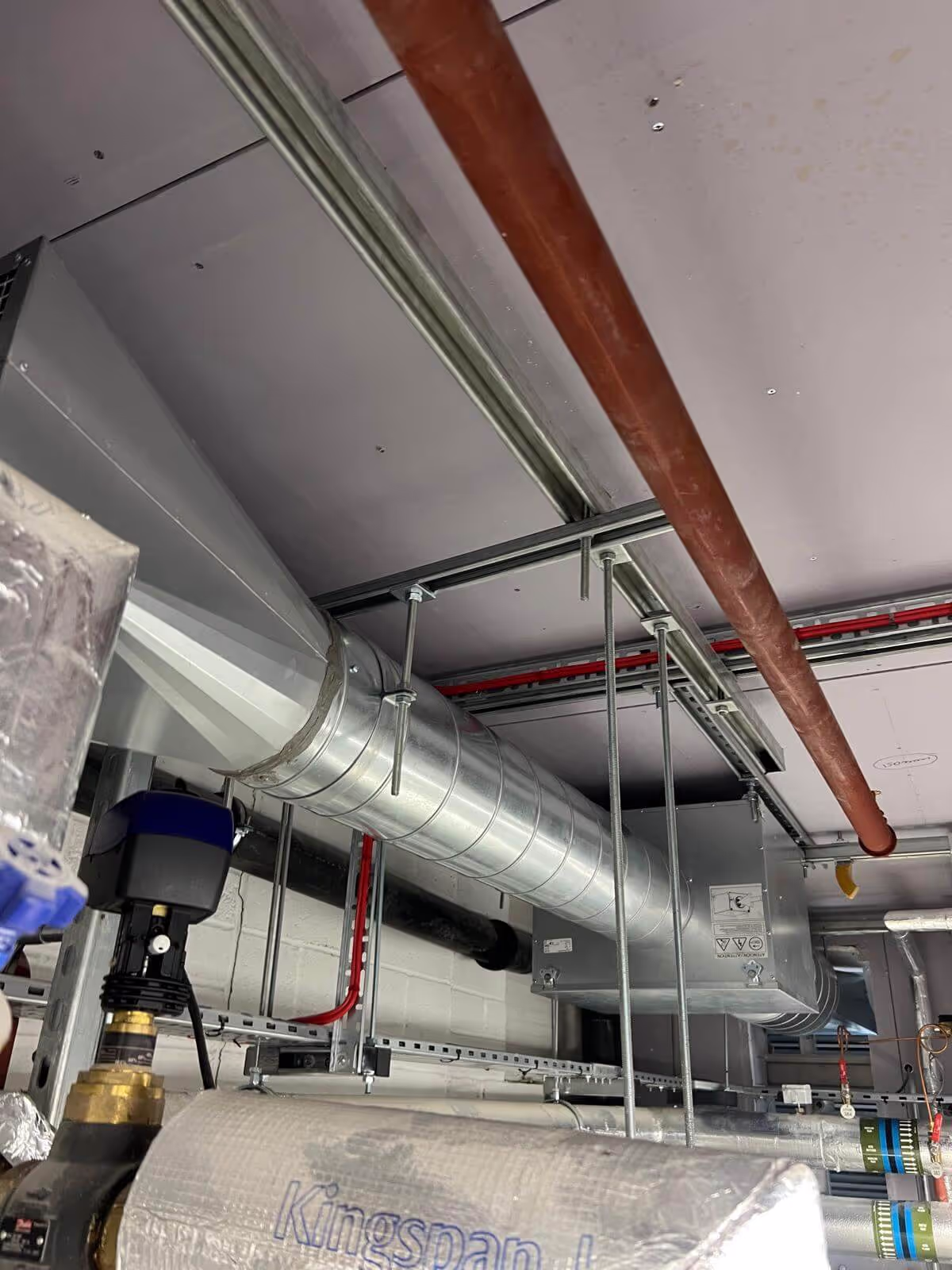 Large ductwork extraction run in a plant room during a commercial ventilation fit-out