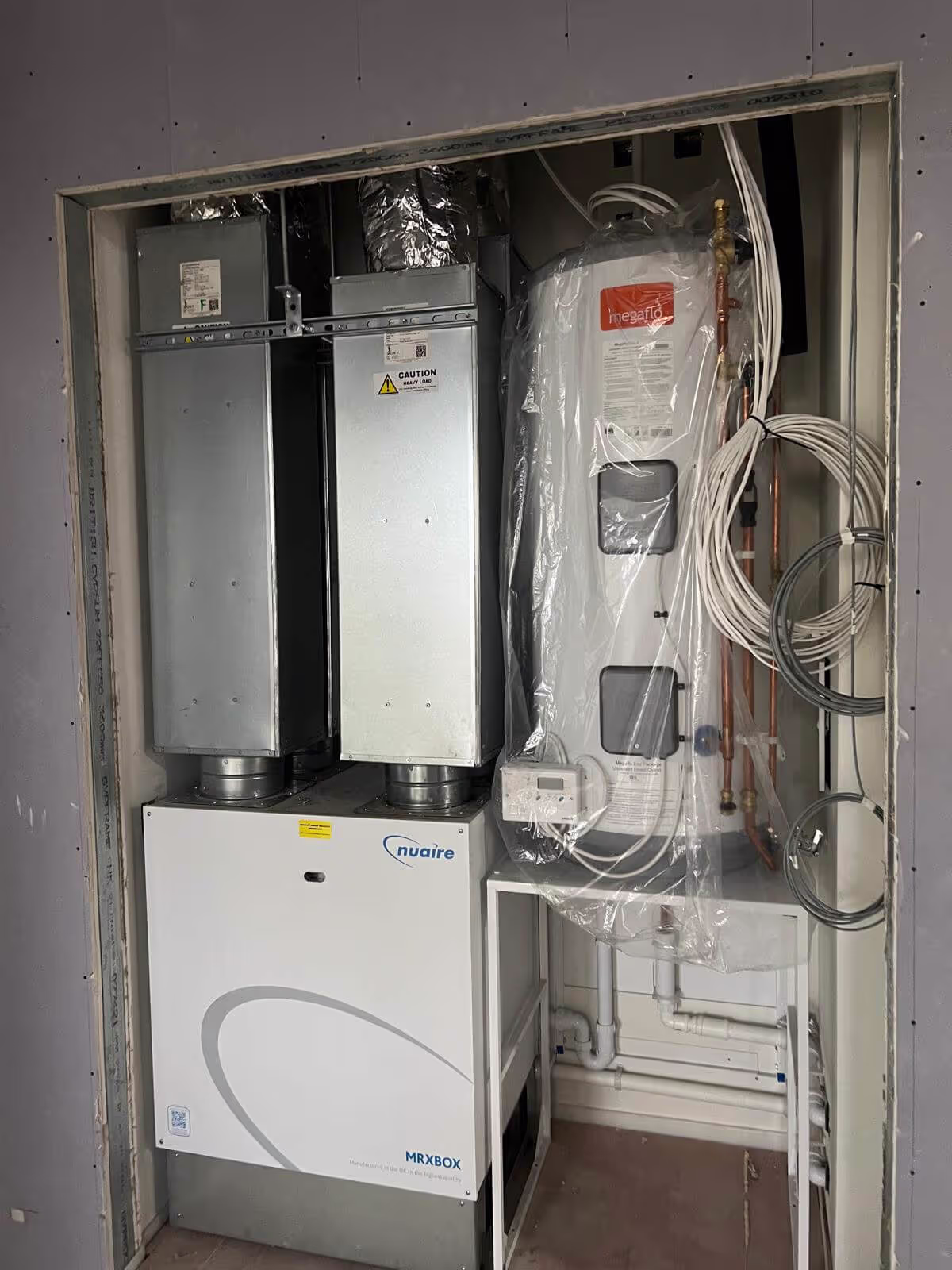 MVHR plant with vertical attenuators installed in a mechanical room